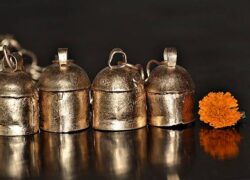 The metal bells of Kutch were originated in Sindh,presently in Pakistan about thousand years ago.The bell is made of iron and coated with copper.They are made out of scrap iron sheets.It is purely handmade and a sustainable craft as scrap iron from junk yards are used for making bells.